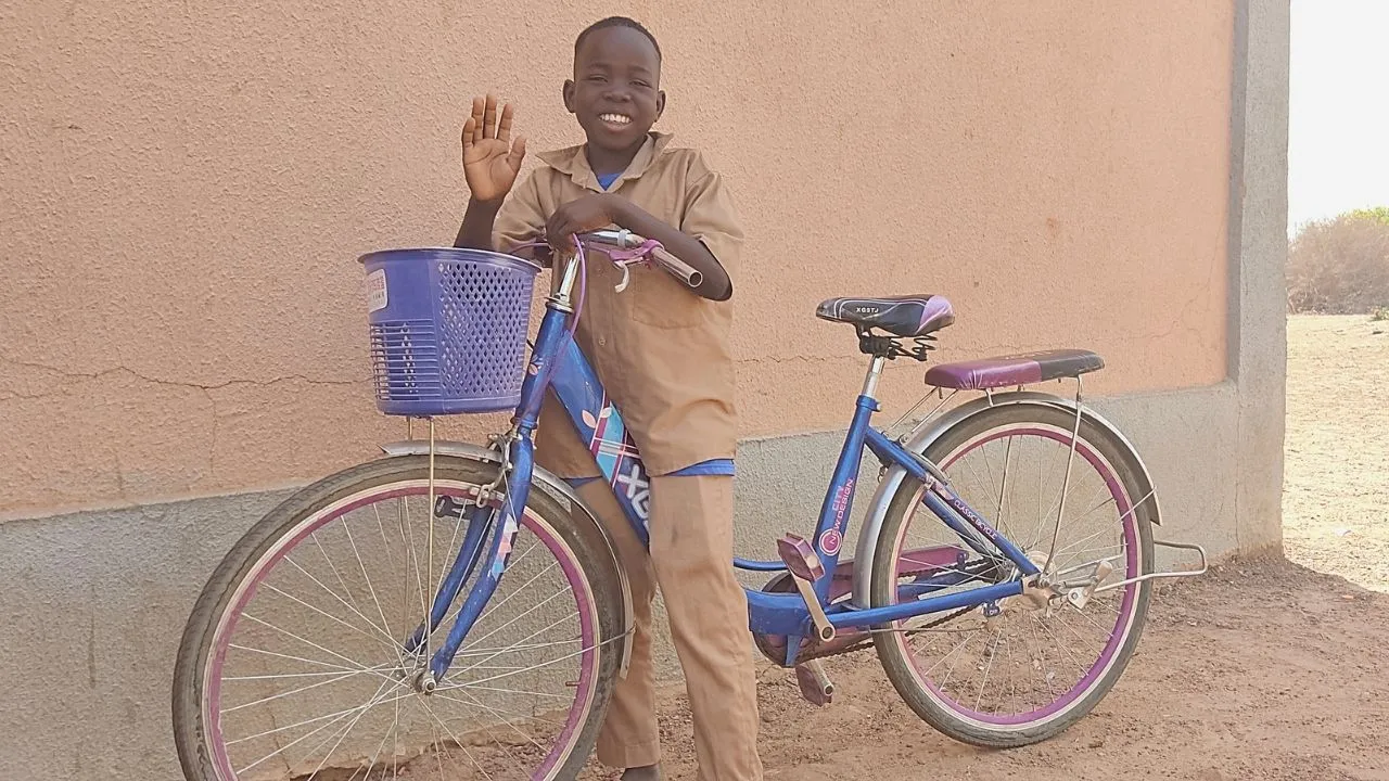Elise Kabore on his bicycle